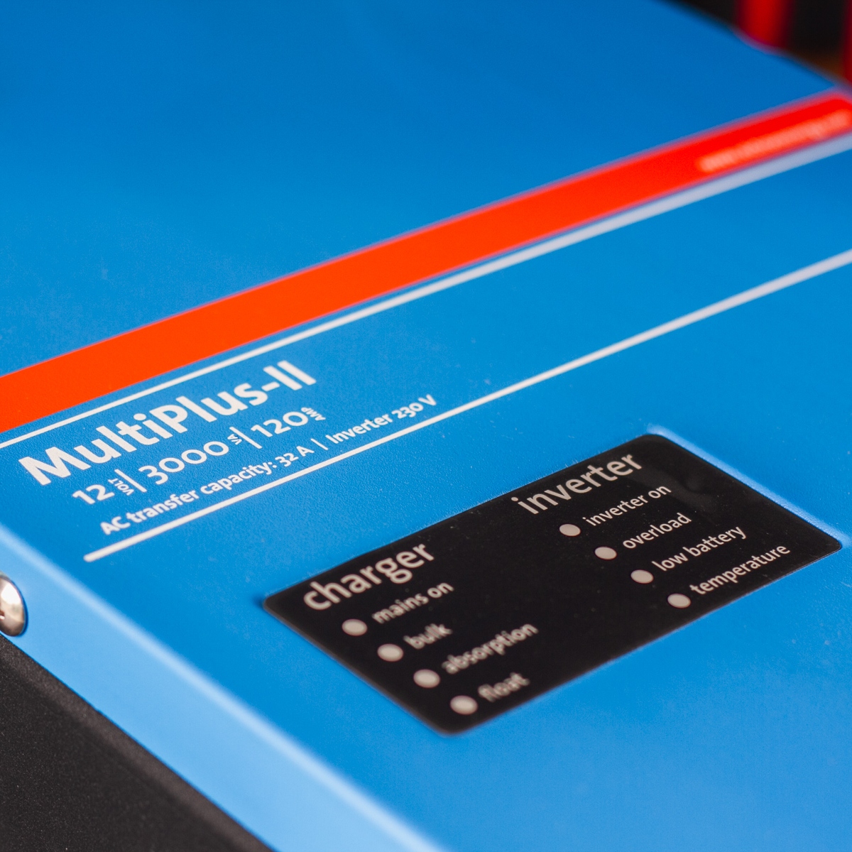 Close-up of a blue and red Victron MultiPlus 3000VA 12V Inverter/Charger, showcasing indicators for charger and inverter status.