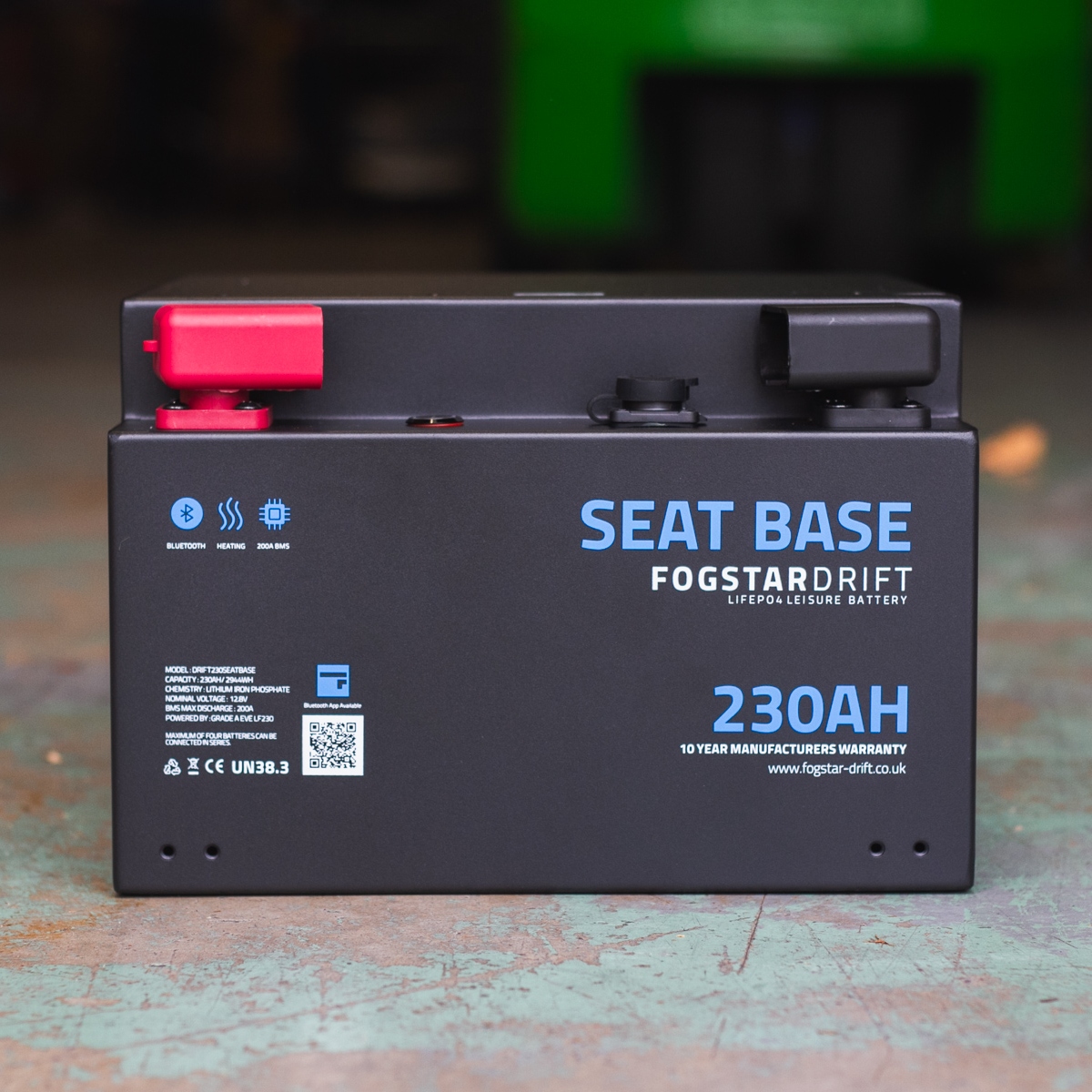 A black Fogstar Drift Seatbase 230Ah 12V lithium leisure battery with red and black terminals and a 10-year warranty.