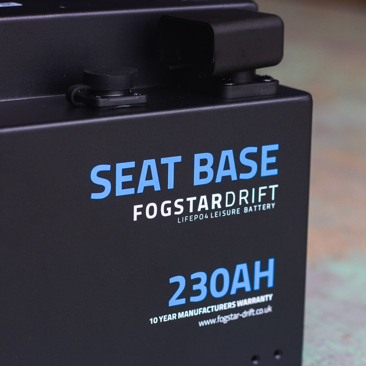 Close-up of a Fogstar Drift Seatbase 230Ah 12V lithium leisure battery marked with text: "Seat Base, 230AH, 10 year warranty.