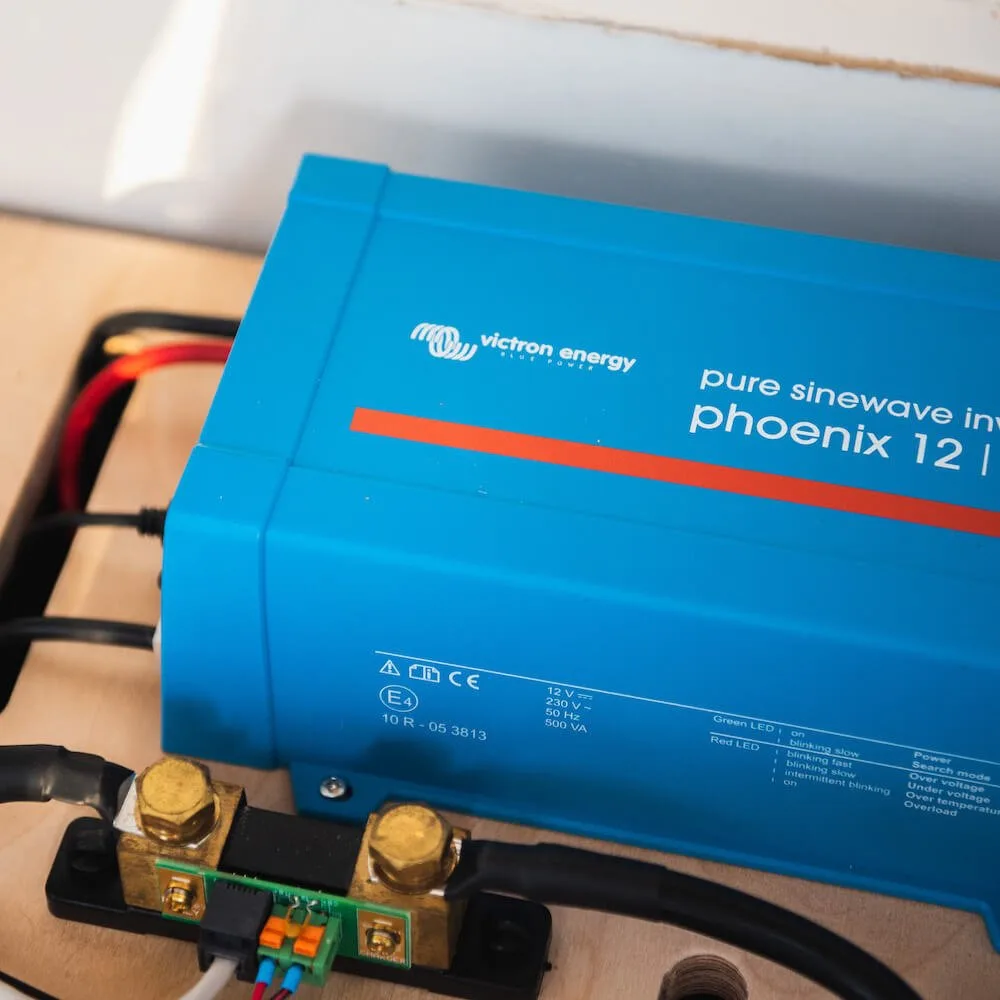 A blue Full campervan electric kit - 2kVA inverter charger‚ hook up‚ 420W solar‚ B2B & batteries installed, with connected wiring visible, seamlessly integrates into your solar-powered campervan electric kit.
