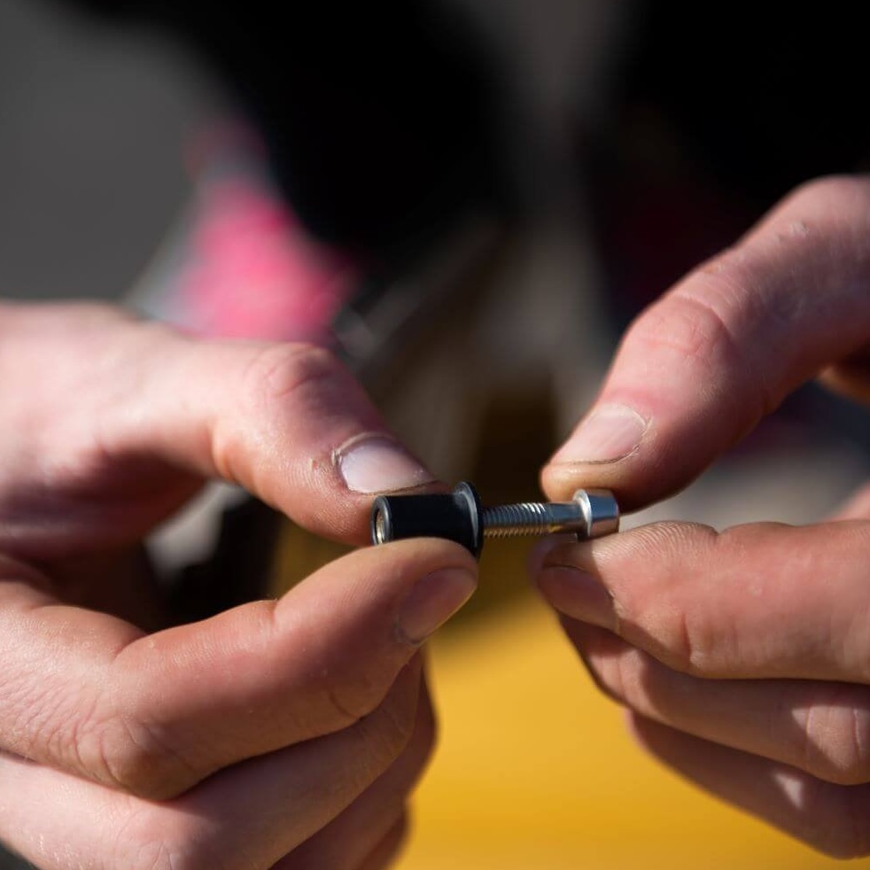 man holding a rubber well nut used for installing campervan solar panels