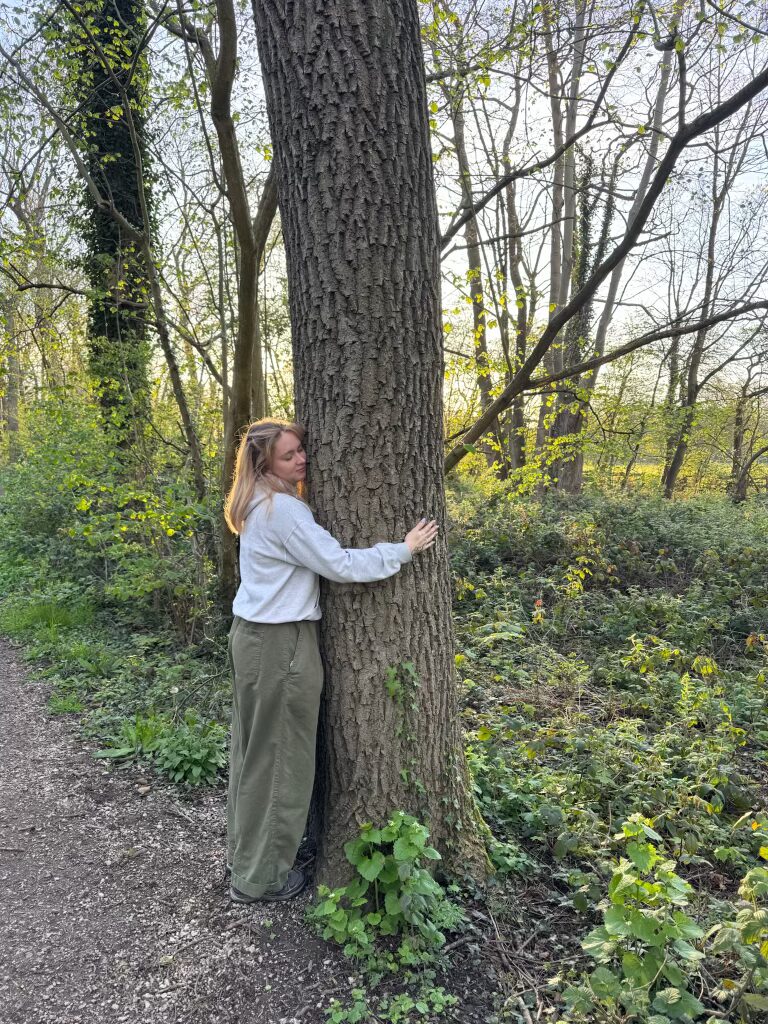 elissa operations assistant at nohma hugging a tree