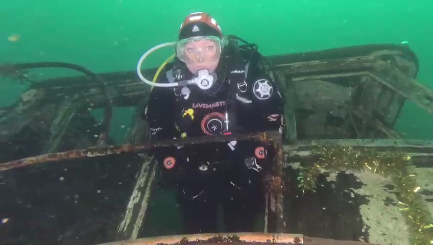 Martina scuba diving out of a shipwreck