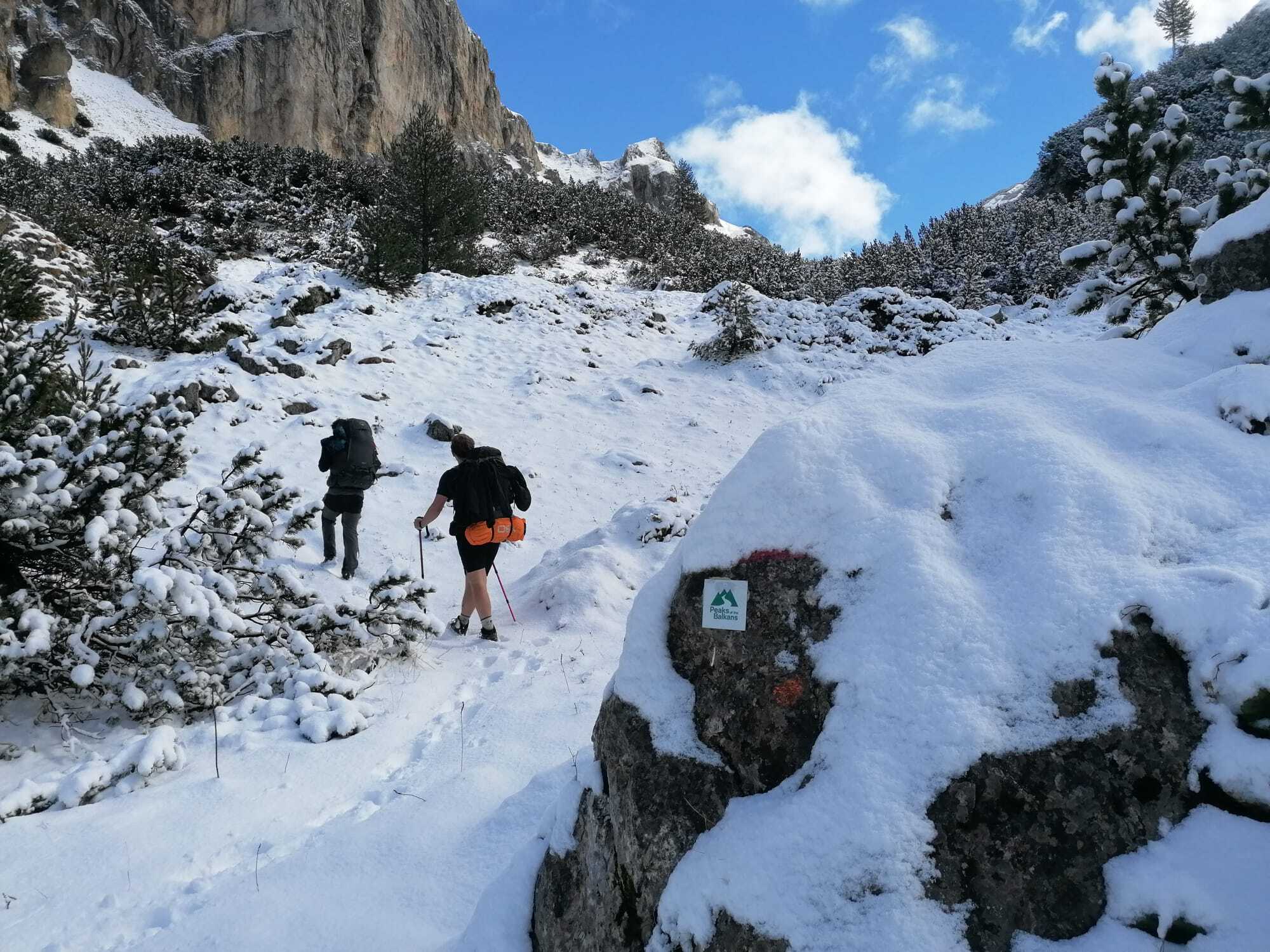Huey hiking through snowy mountains